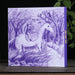 Purple box with a man on a horse illustration on a wooden surface with a tea cup and trees in the background.