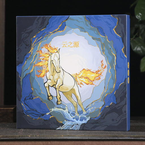 Decorative box with a horse design on a wooden surface with a plant and teapot in the background