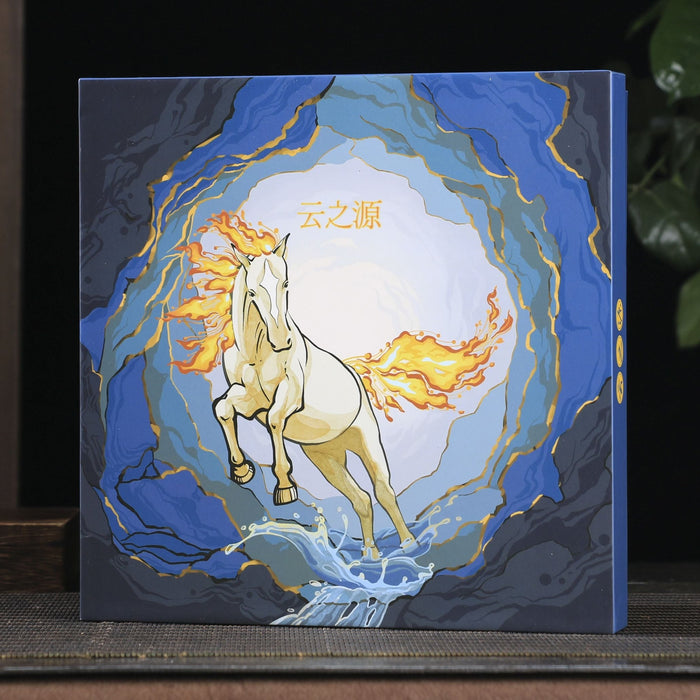 Decorative box with a horse design on a wooden surface with a plant and teapot in the background