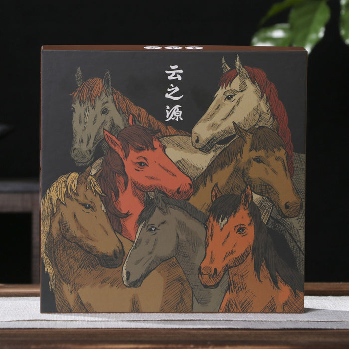 A square decorative pu-erh tea gift box or book cover featuring an illustration of several horses in warm earthy tones, standing on a tabletop with a dark background and blurred green leaves behind it.